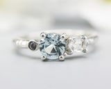 Sterling silver wedding ring with blue topaz, oval moonstone and tiny labradorite gemstone in bezel and prongs setting