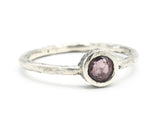 Round cut pink spinel ring in bezel setting with sterling silver texture band