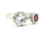 Round faceted white topaz ring in silver bezel setting and tiny ruby on sterling silver hammer texture band