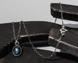 Blue star sapphire pendant necklace in silver bezel setting with sterling silver chain