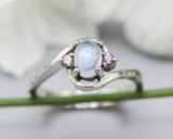 Oval moonstone cabochon ring and twin side set amethyst with sterling silver hammer texture band