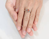 Oval sunstone ring with tiny labradorite side set gems in prongs setting with sterling silver texture band