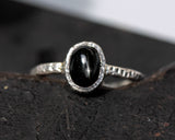 Black star diopside ring in silver bezel setting with hammer textured sterling silver band
