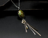 Oval green turquoise pendant necklace with silver flower and silver chain decoration