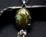 Oval green turquoise pendant necklace with silver flower and silver chain decoration