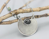 Oval Black Star Diopside gemstone pendant necklace with silver crescent moon shape on sterling silver chain