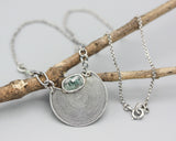 Crescent moon necklace with oval mint kyanite in silver bezel setting