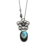 Oval Labradorite pendant necklace in silver bezel setting with silver in flower shape on silver chain