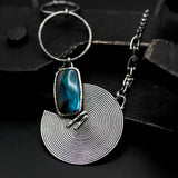 Rectangle cabochon labradorite pendant necklace with silver circle in spiral design on sterling silver chain