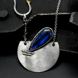 Teardrop Labradorite pendant necklace with silver semi-circle in matte finish brush texture on sterling silver chain