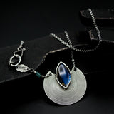 Marqiuse cabochon labradorite pendant necklace with silver circle in spiral design on sterling silver chain