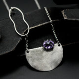 Oval Amethyst pendant necklace in silver bezel and prongs setting with silver semi-circle shape on sterling silver chain
