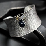 Sterling silver cuff bangle bracelet with oxidized line textured and decorated with blue sapphire, labradorite and moonstone gemstone
