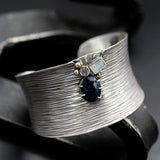 Sterling silver cuff bangle bracelet with oxidized line textured and decorated with blue sapphire, labradorite and moonstone gemstone