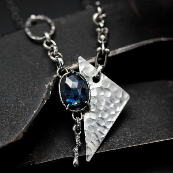 Oval Blue kyanite pendant necklace in silver bezel and prongs setting with silver triangle shape on oxidized sterling silver chain