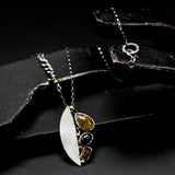 Teardrop Rutilated quartz pendant necklace, orange kyanite and black star diposide with silver semi-oval on sterling silver chain