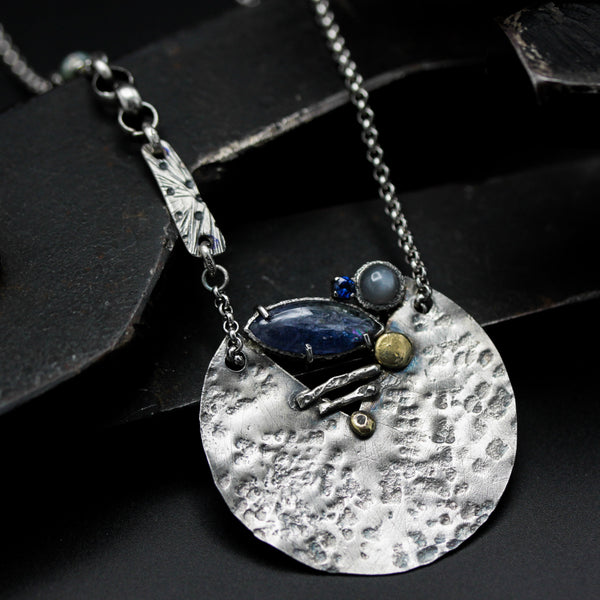 Marquise Iolite, moonstone and blue sapphire pendant necklace set in silver textured circle shape with sterling silver chain