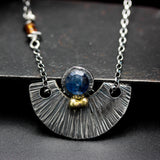 Round blue Kyanite gemstone pendant necklace with silver fan shape on sterling silver chain