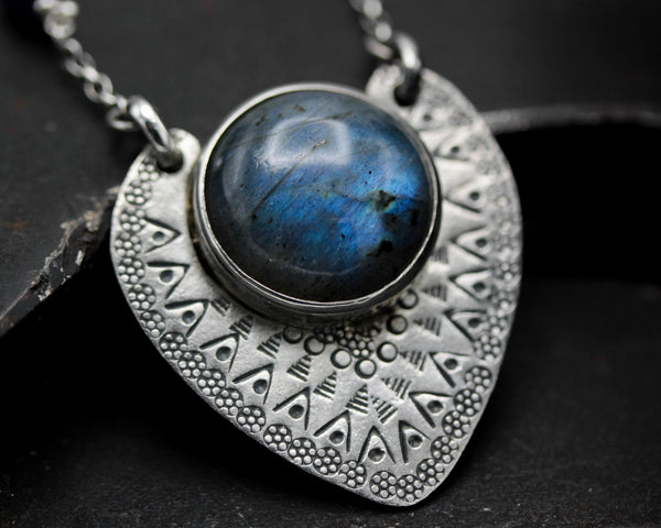 Round cabochon labradorite pendant necklace in silver bezel setting with silver in engraving technique