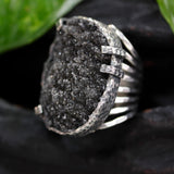 Oval black Brazilian raw druzy ring in silver bezel and prongs setting with silver skeleton band