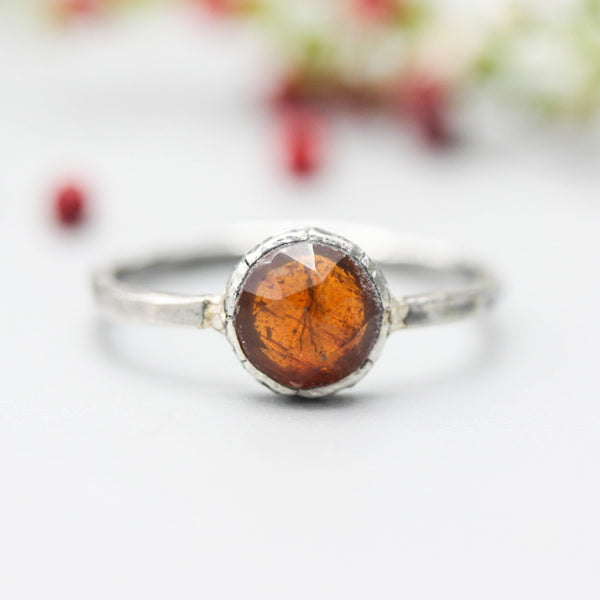 Round orange kyanite ring in silver bezel setting with sterling silver hammer texture band