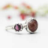 Round faceted Moss agate ring in silver bezel setting with garnet on oxidized sterling silver band