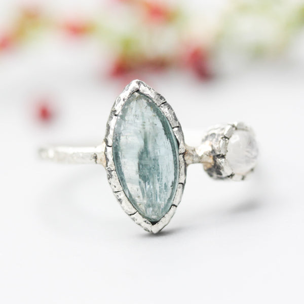 Marquise faceted Paraiba Kyanite ring in silver bezel setting with round Moonstone on sterling silver hard texture band