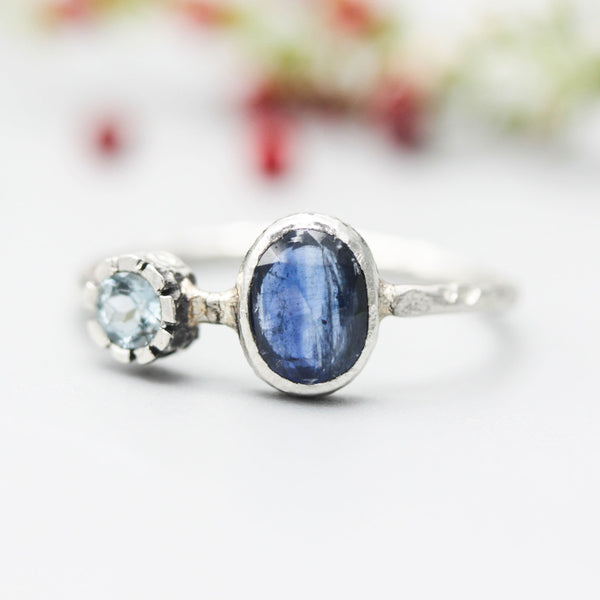 Oval faceted Blue Kyanite ring in silver bezel setting with round blue topaz on sterling silver hard texture band