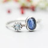 Oval faceted Blue Kyanite ring in silver bezel setting with round blue topaz on sterling silver hard texture band