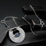 Crescent moon necklace with marquise blue kyanite in silver bezel setting