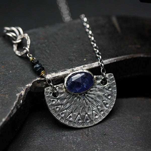 Oval blue Kyanite gemstone pendant necklace with silver fan shape on sterling silver chain