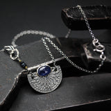 Oval blue Kyanite gemstone pendant necklace with silver fan shape on sterling silver chain
