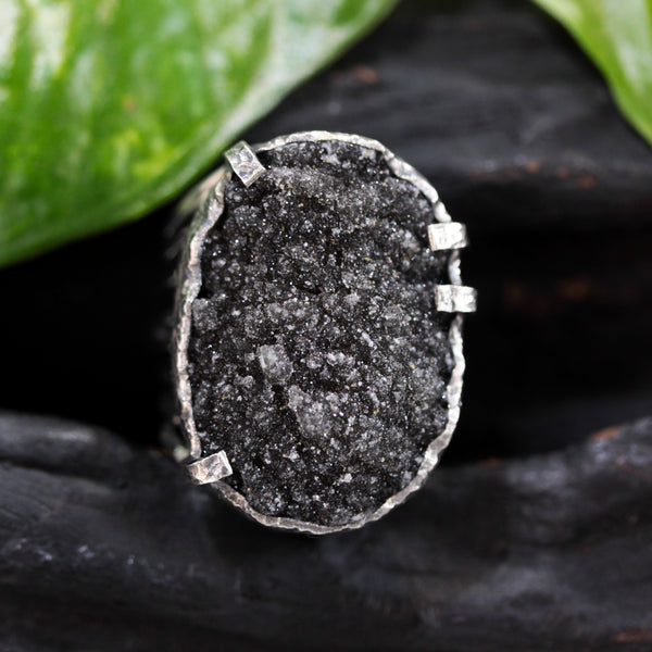 Oval black Brazilian raw druzy ring in silver bezel and prongs setting with silver skeleton band