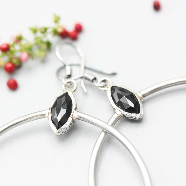 Black onyx earrings in silver bezel setting with silver circle loop on hooks style
