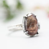 Teardrop faceted Moss agate ring with blue sapphire on the side on sterling silver hammer texture band