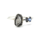 Oval Rough diamond ring in silver bezel setting and round faceted blue sapphire on the side with sterling silver band