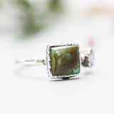 Square turquoise ring in silver bezel setting with tiny tanzanite on the side with sterling silver hammer texture band