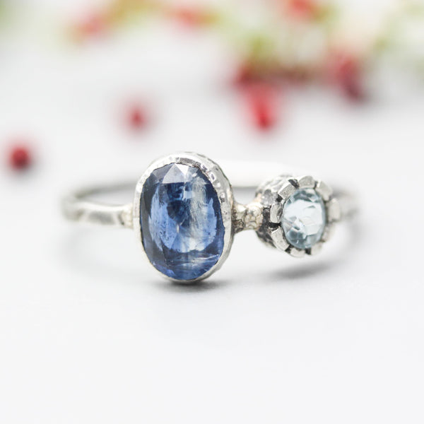 Oval faceted Blue Kyanite ring in silver bezel setting with round blue topaz on sterling silver hammer texture band